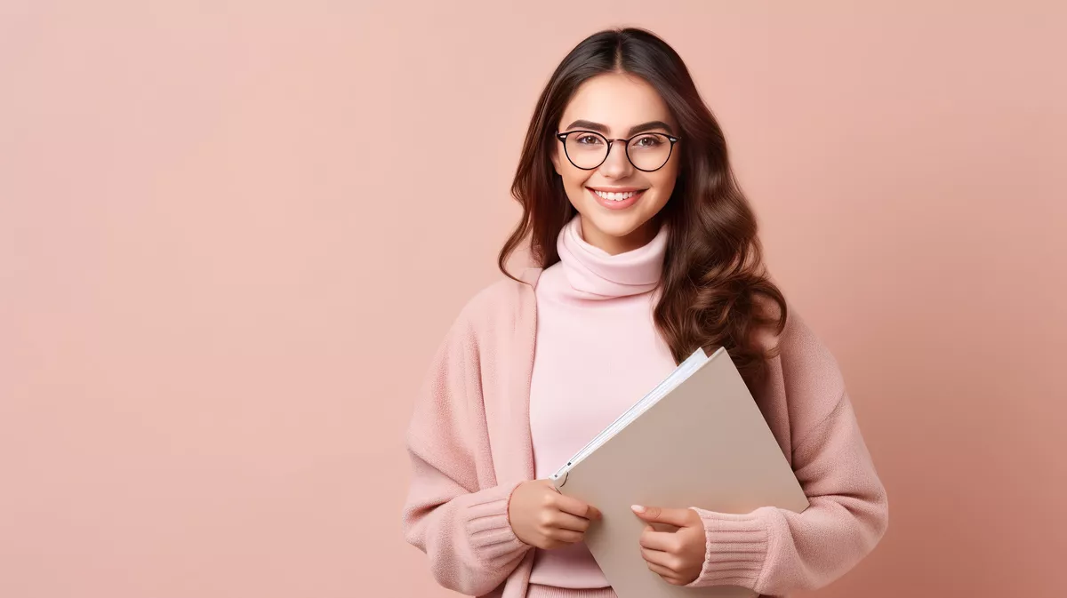 Front view young female student in grey coat with copybooks on pink background lessons university college