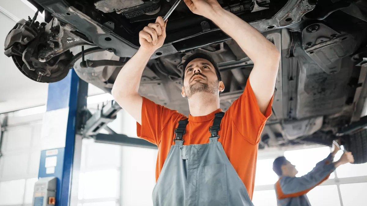 A Motor Vehicle Technician at work.