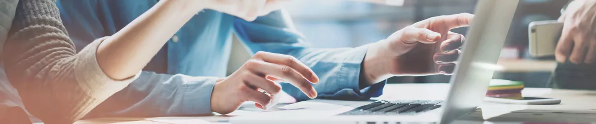 Business people using laptop in office