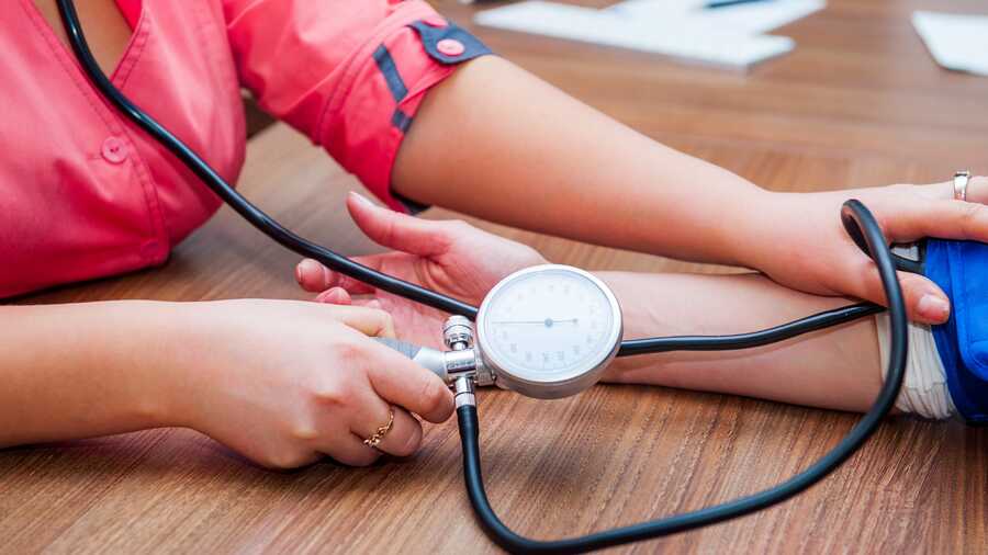 Medizinische Fachangestellte messen den Blutdruck von Patienten
